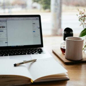 Image of laptop and notebook with pen